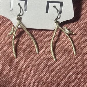 Silver colored bird on a branch earrings